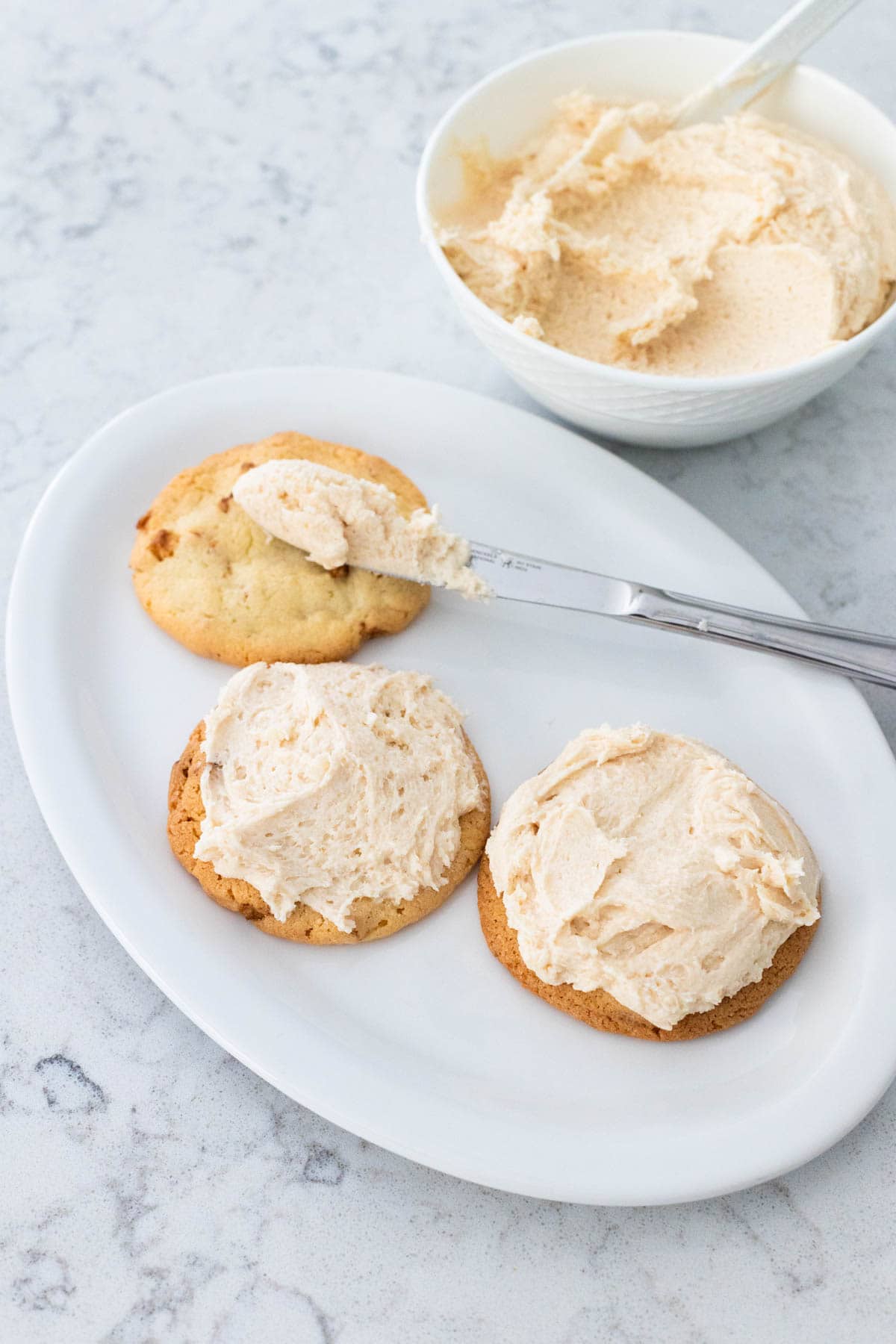 The frosting has been spread over the cookies.