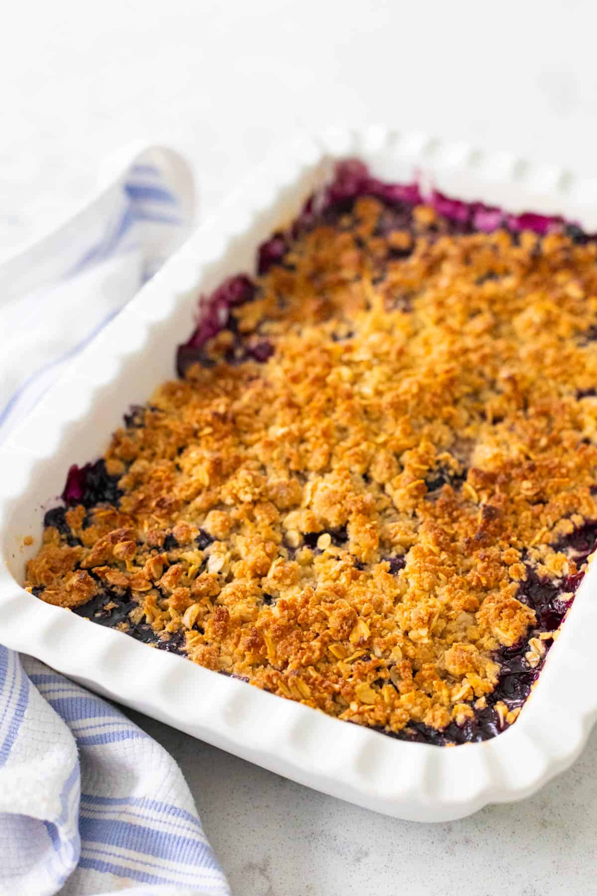 The finished fruit dessert is cooling on the counter, the crisp topping is a gorgeous golden brown.