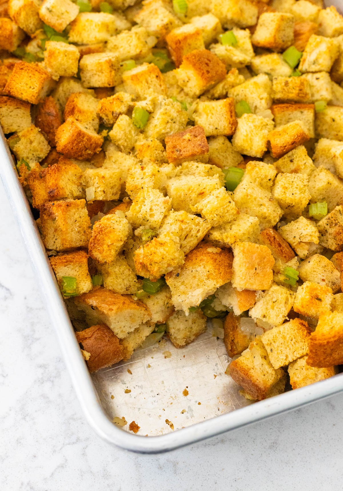 The golden brown stuffing has a spoonful missing.