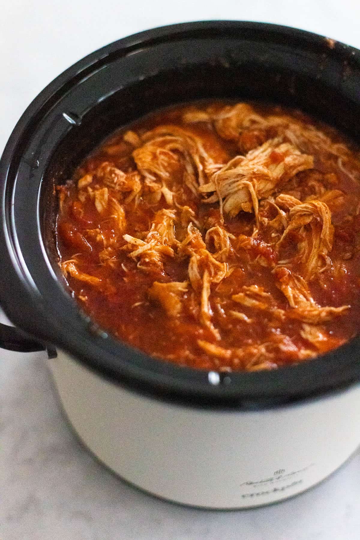 The chicken has been cooked and then shredded right in the slowcooker.