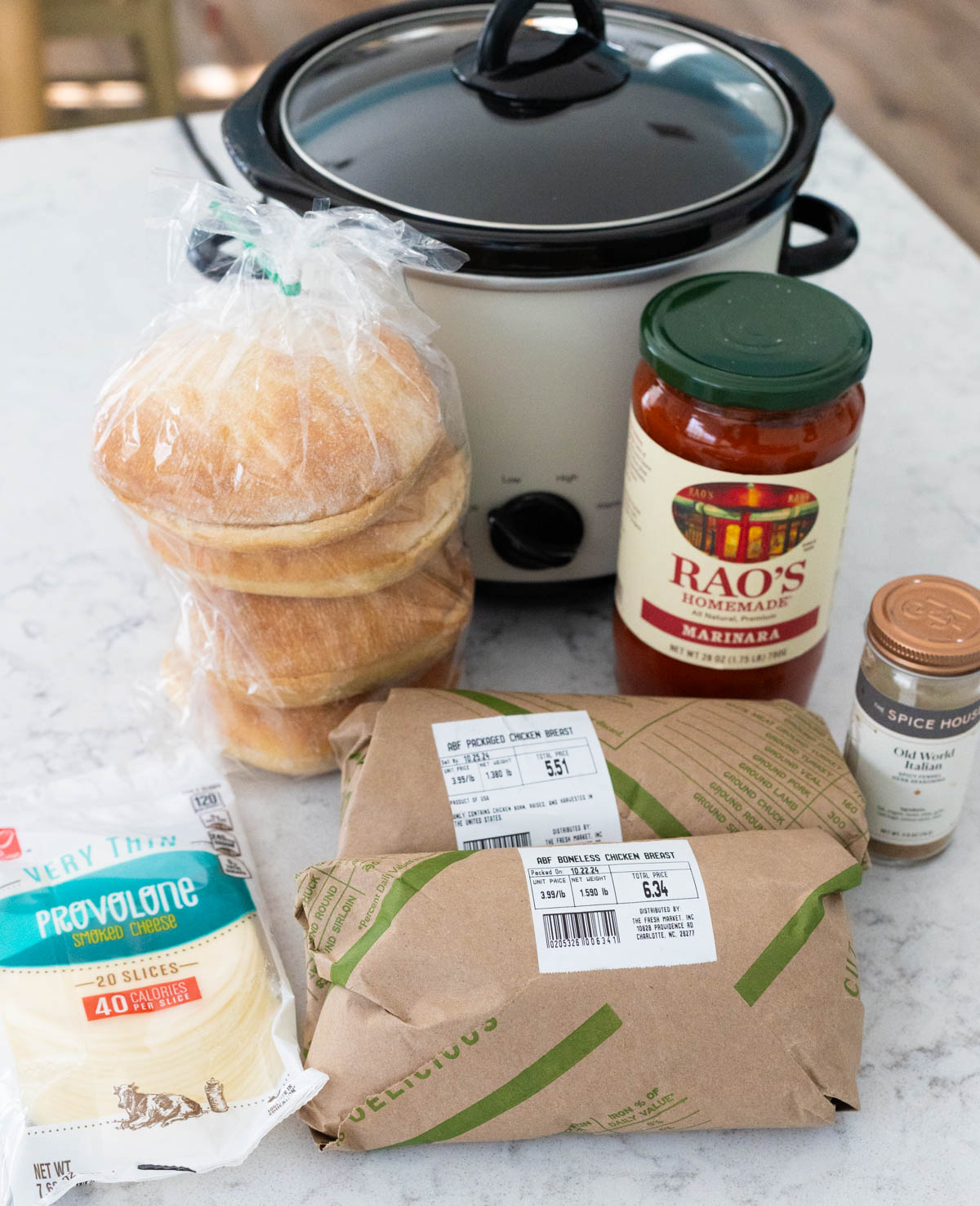 The ingredients to make the Italian chicken sandwiches are on the counter next to a crockpot.