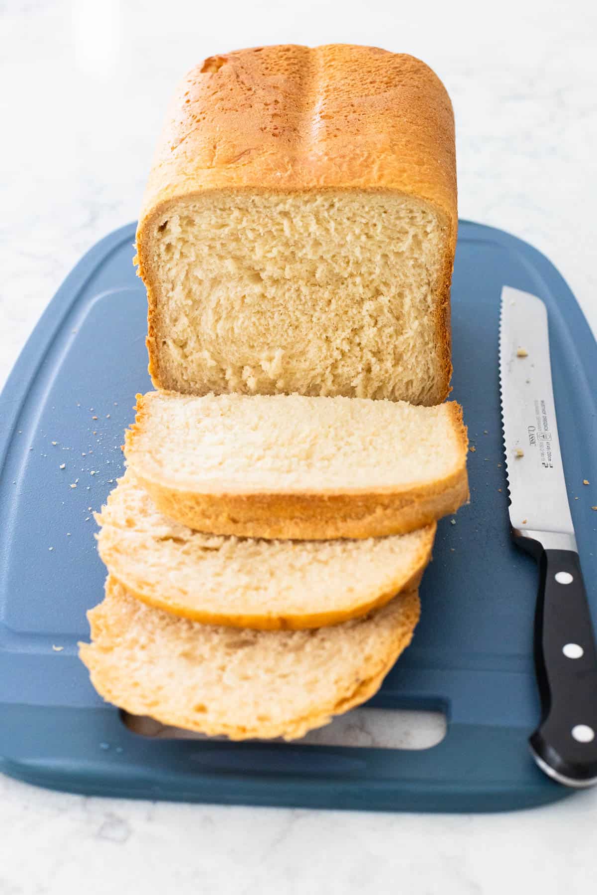 The loaf has been sliced on a cutting board.