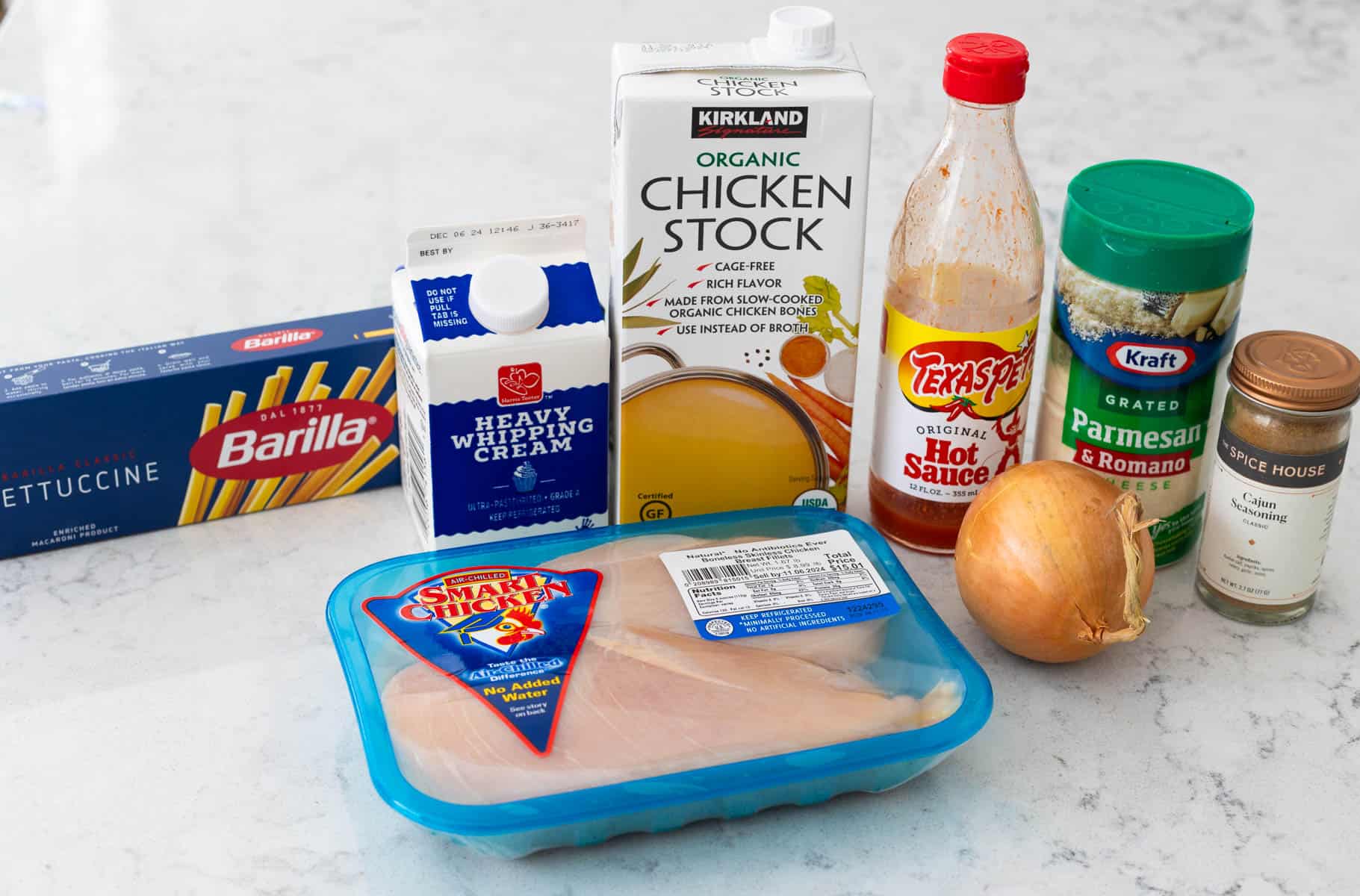 The ingredients to make cajun chicken pasta in the slowcooker are on the counter.