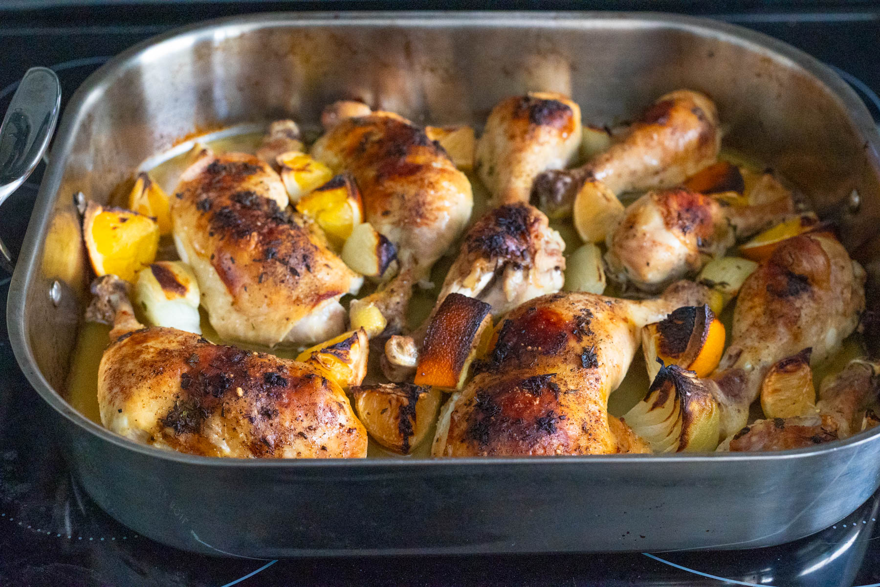 The chicken has just come out of the oven and is golden brown.