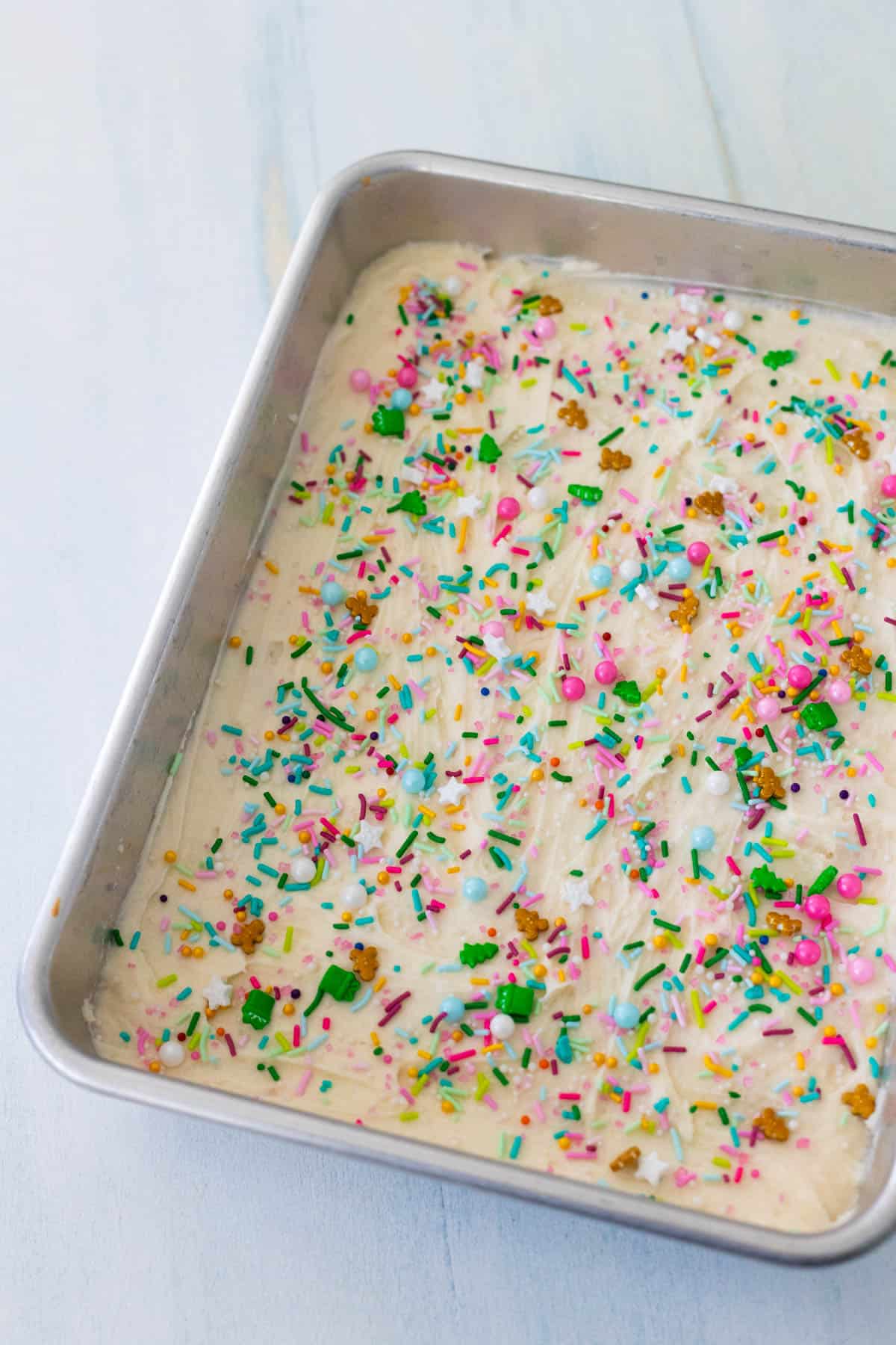 The cookie bars have been decorated with pink, green, red, and light blue sprinkles.