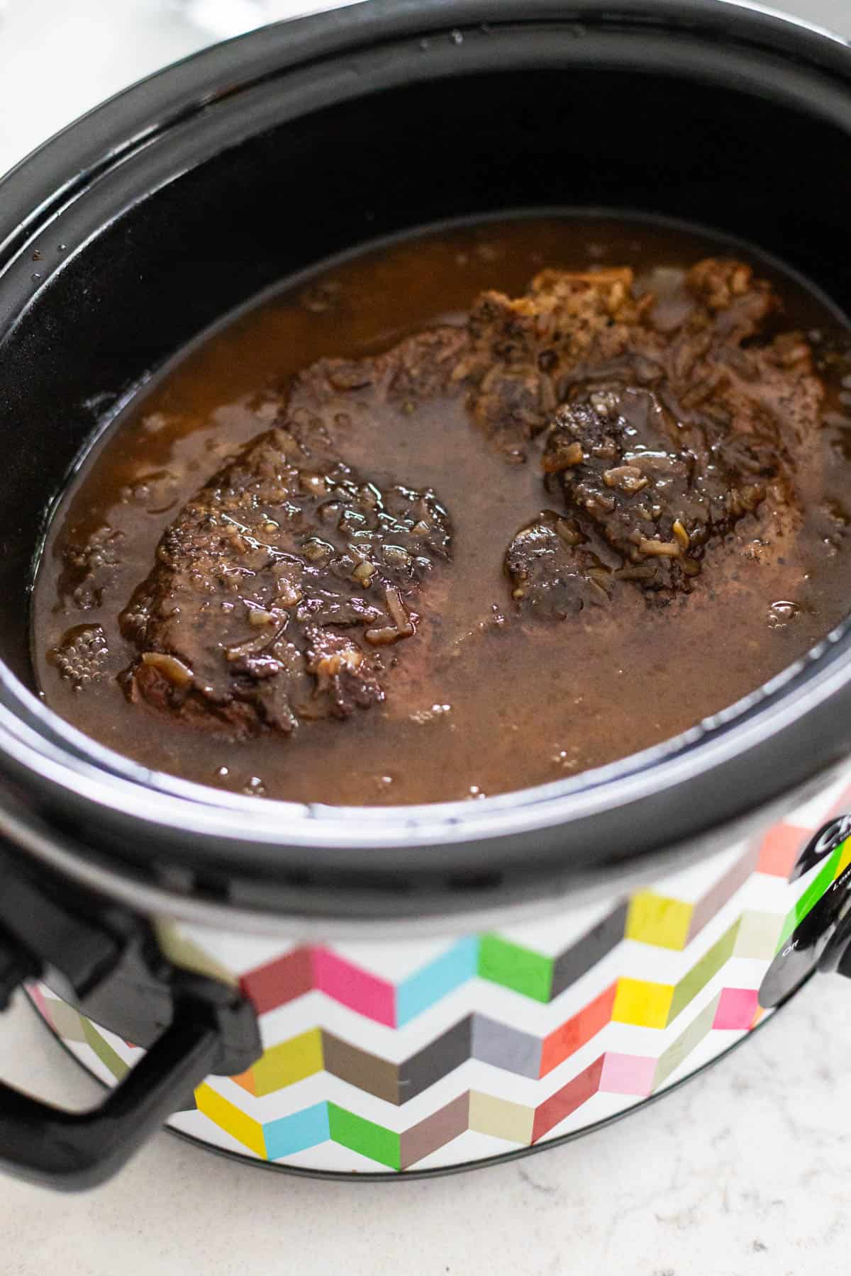 The beef has been cooked in the slowcooker and the juices are now a rich gravy.