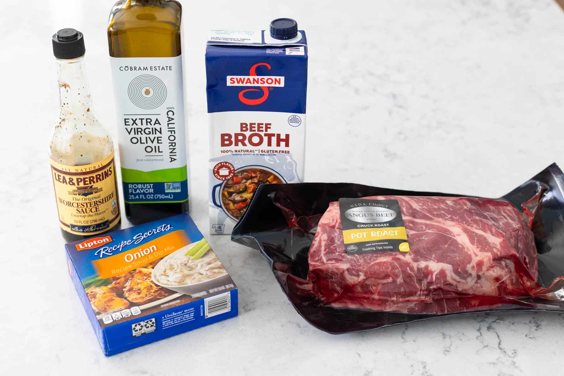 The beef and seasonings to make french dip sandwiches in the slowcooker are on the counter.