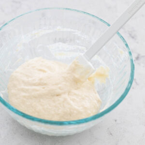 A mixing bowl has a portion of sourdough starter that has just been fed.