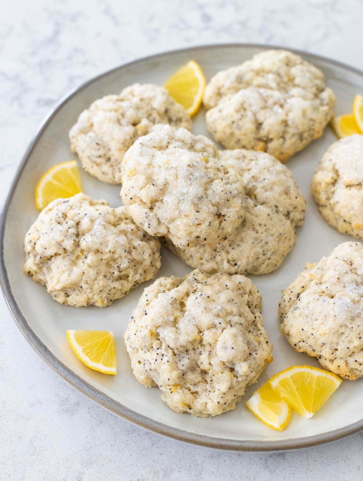 A platter of lemon scones has fresh lemon slices for garnish.