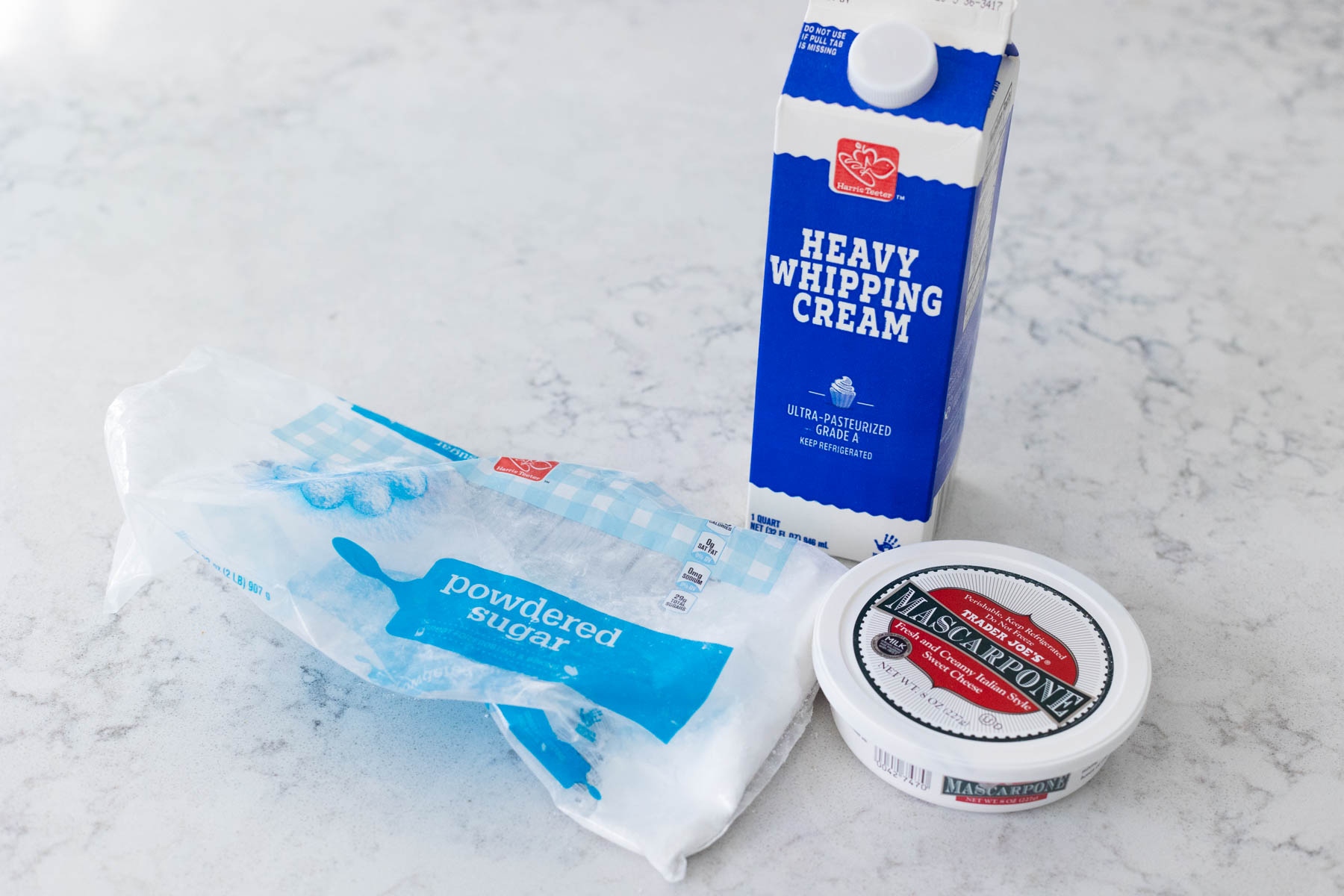 The powdered sugar, heavy cream, and mascarpone cheese are on the counter.