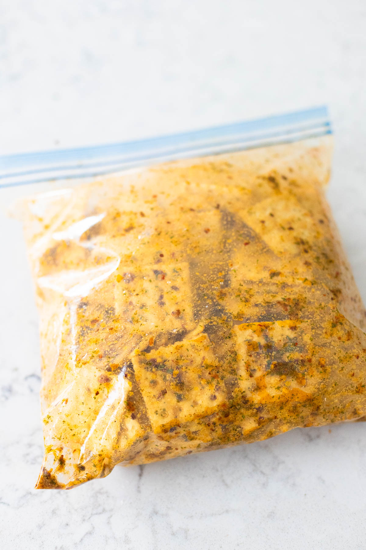 The seasoned saltine crackers rest in the storage bag overnight.