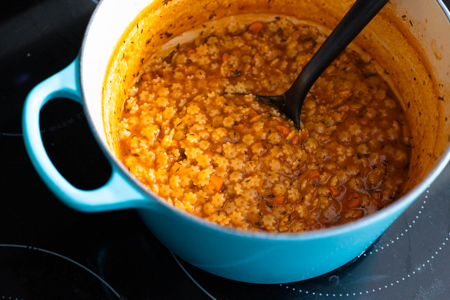 The finished pastina soup is ready, the pasta is tender and the sauce is thickened.