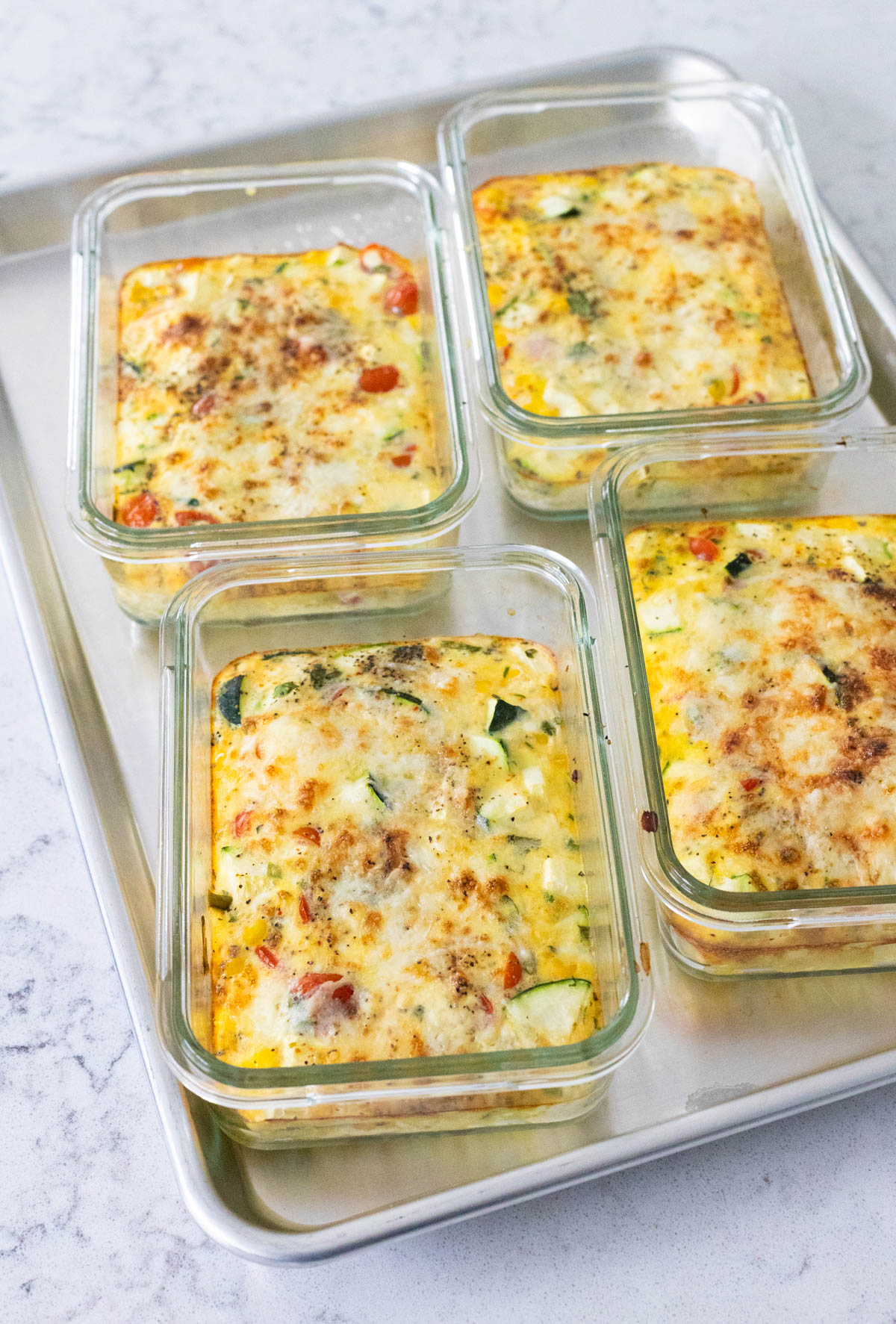 The egg bowls are on a baking pan, fresh from the oven.