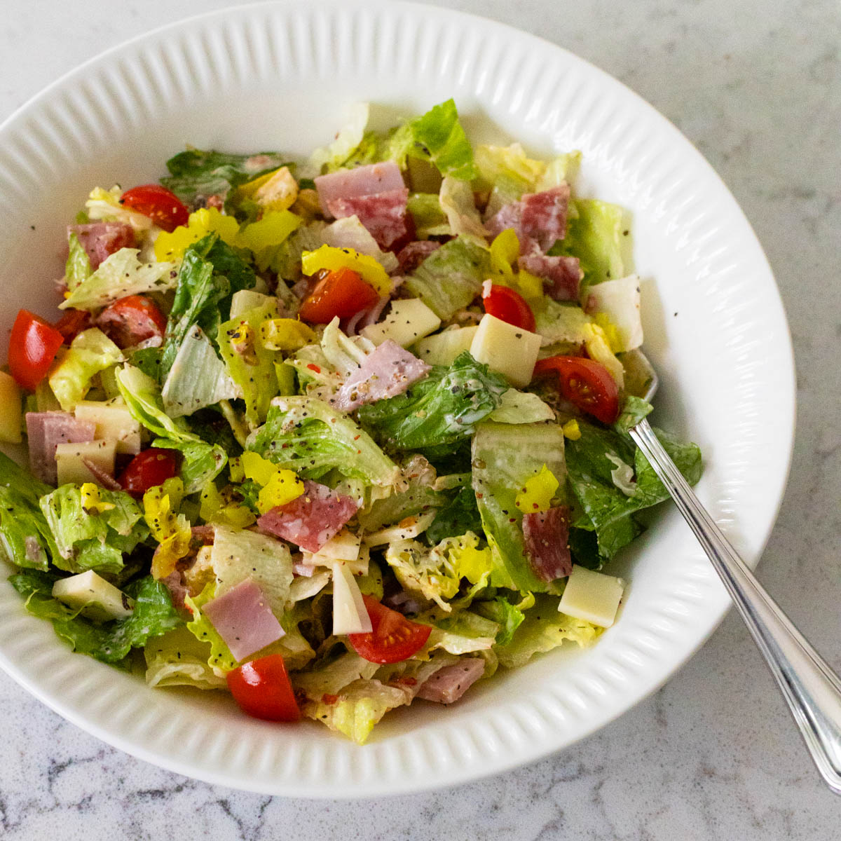 The grinder salad has been tossed in the creamy dressing.