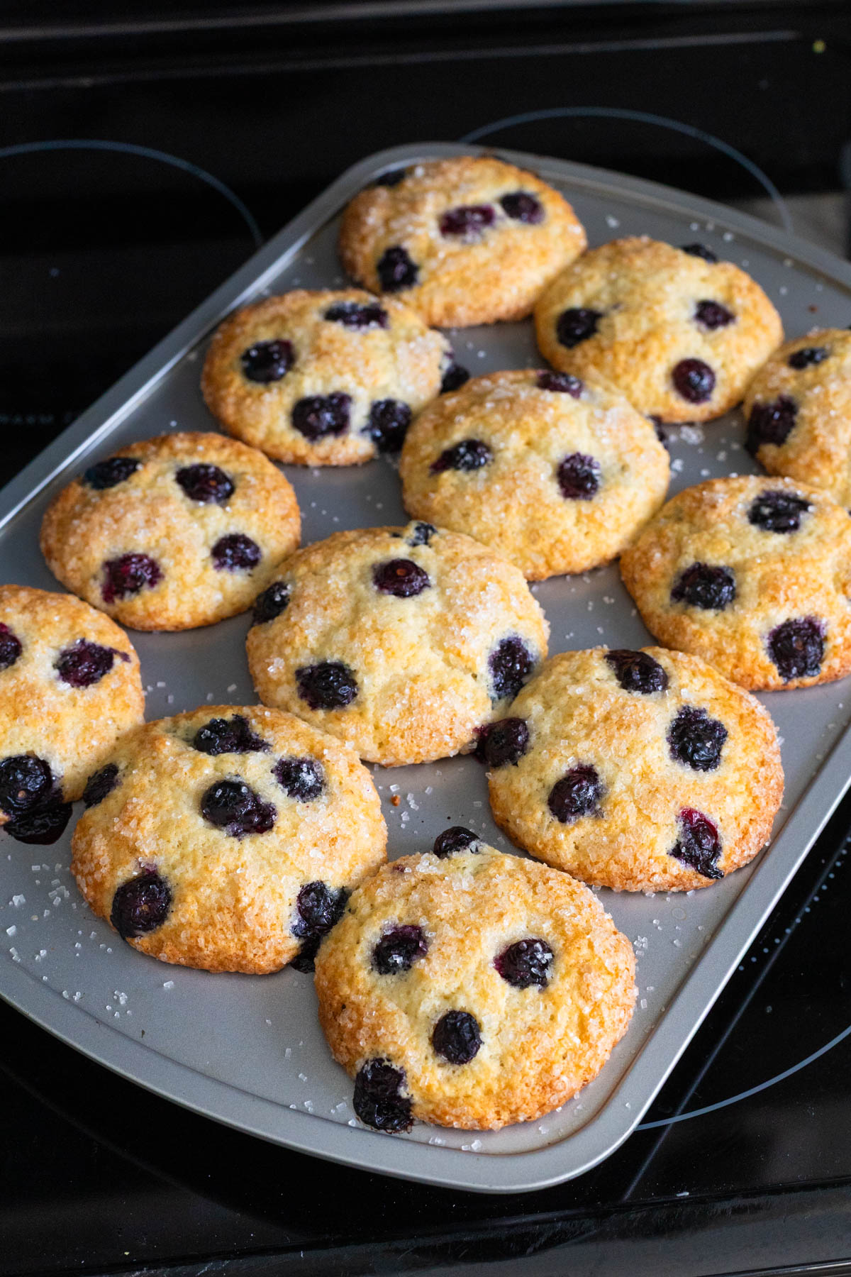 The pan of muffins has just come out of the oven, the tops are golden brown.