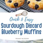 A batch of blueberry muffins with a sparkly sugar topping are cooling on a baker's rack next to a blue and white striped towel.