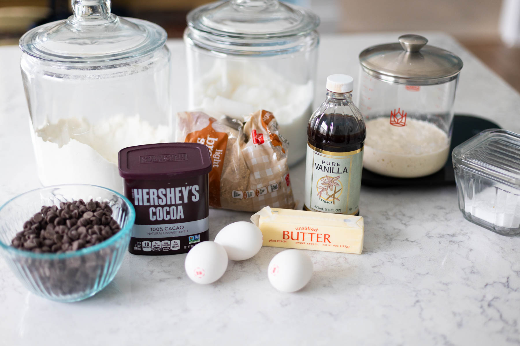The ingredients to make the brownies are lined up on the counter.