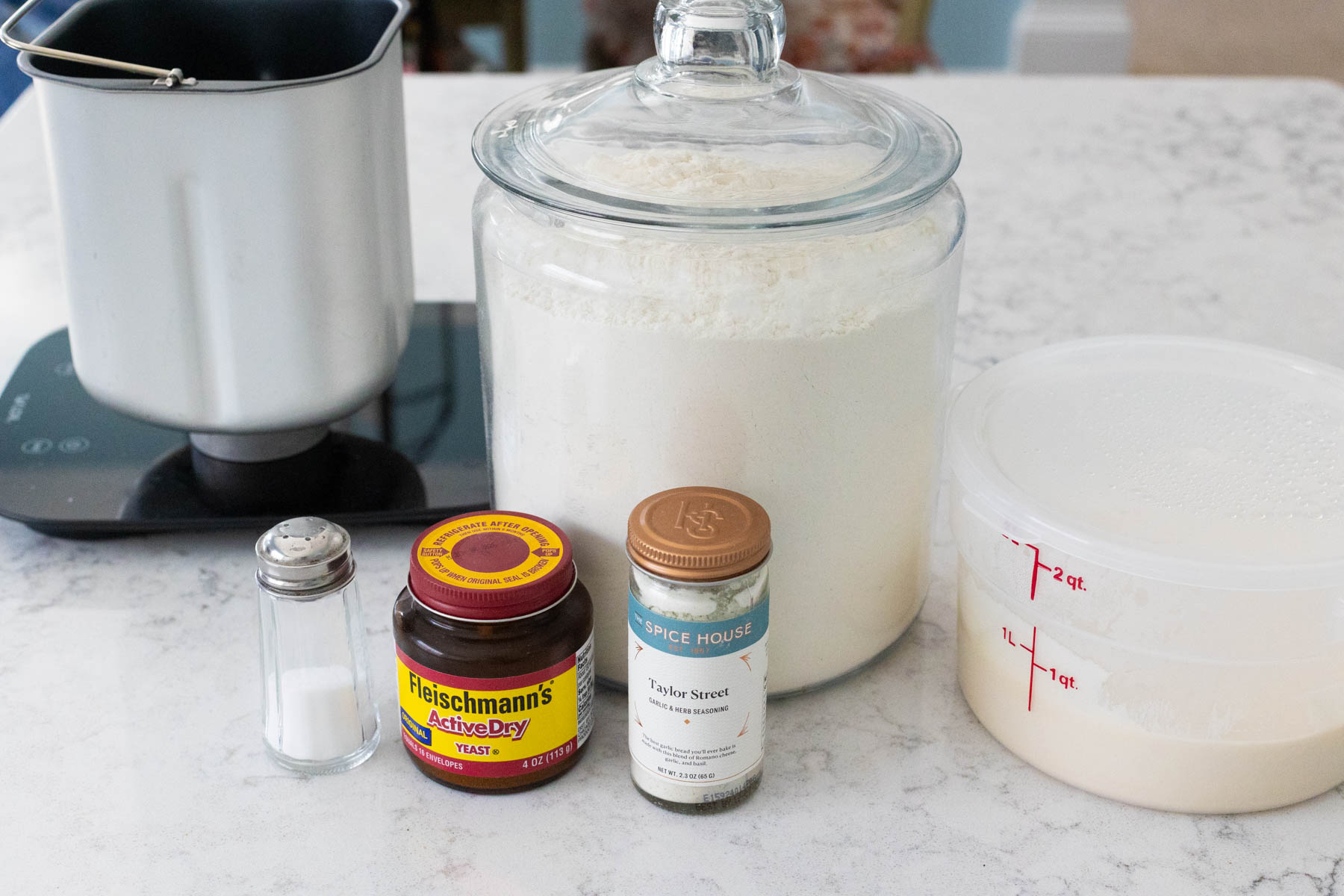 The ingredients to make sourdough discard pizza dough are on the counter.