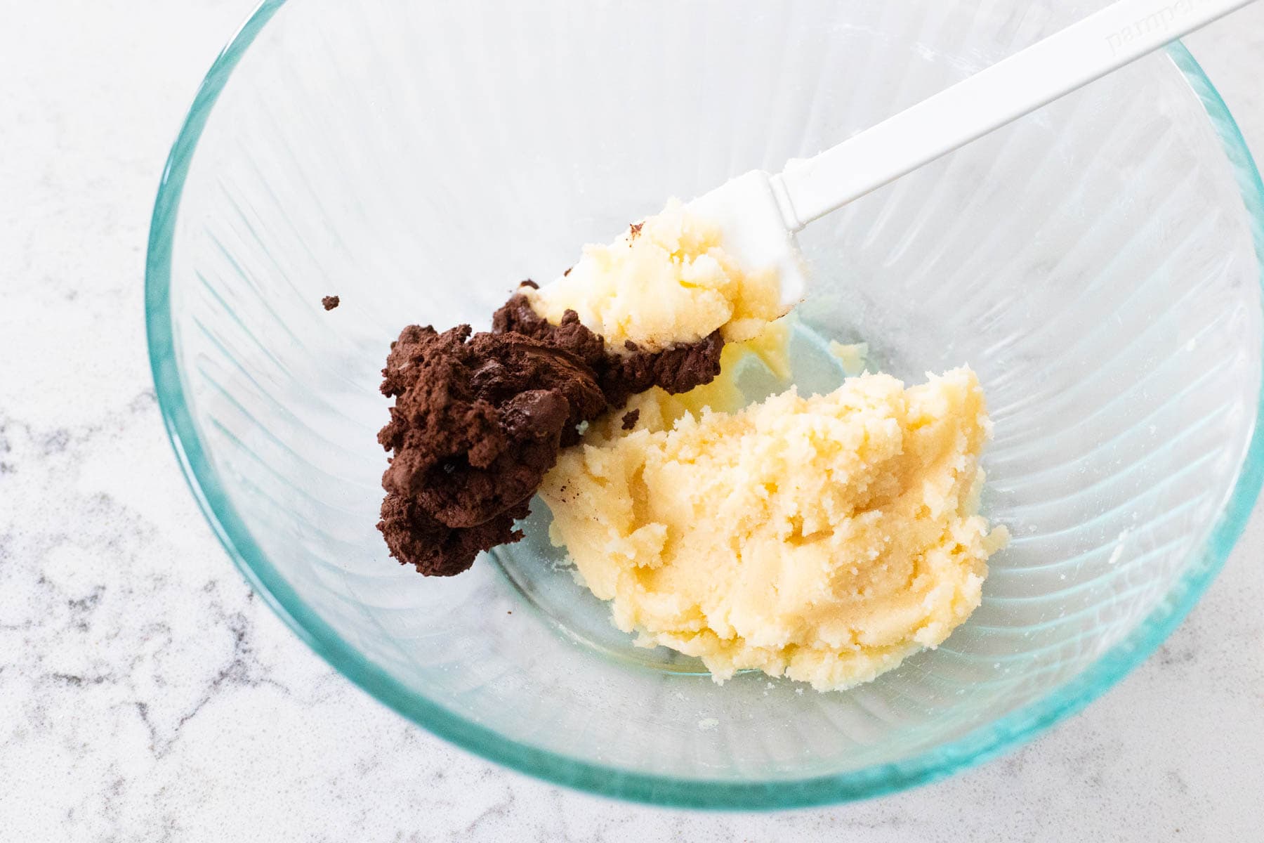 The chocolate paste has been added to the butter mixture.