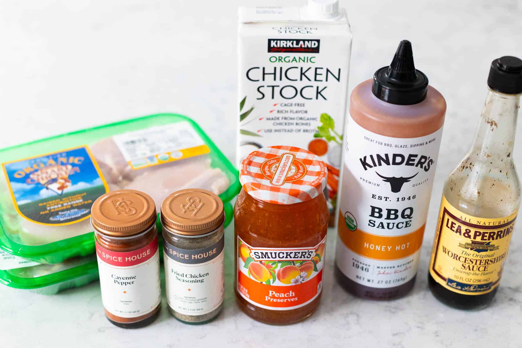 The ingredients to make BBQ peach chicken is on the kitchen counter.