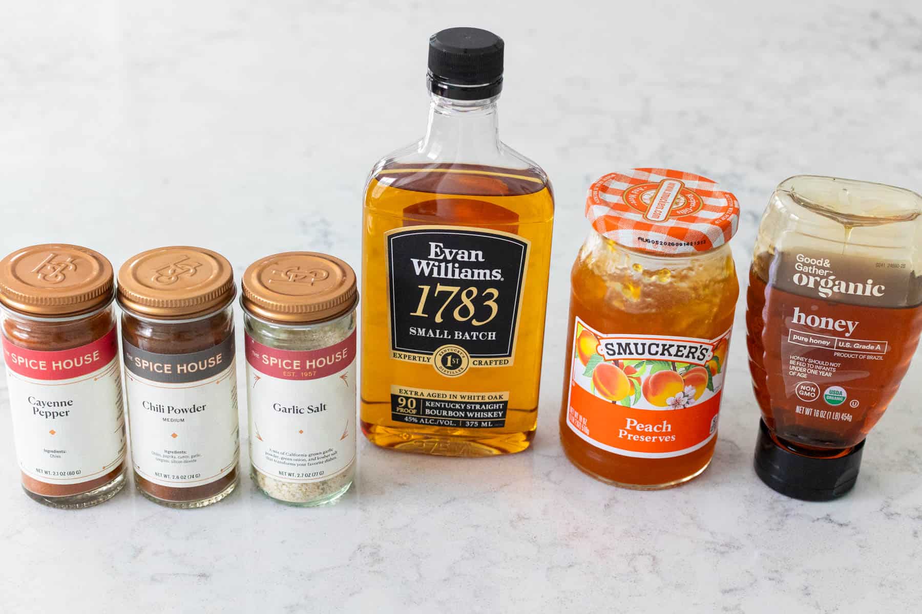 The ingredients to make the bourbon peach glaze are on the kitchen counter.
