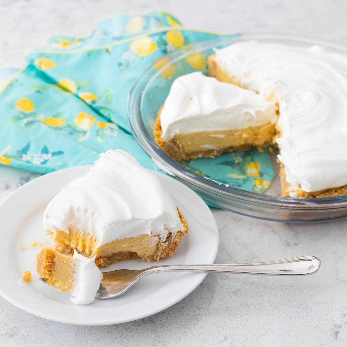 The pie has been topped with a whipped topping and then sliced and served.
