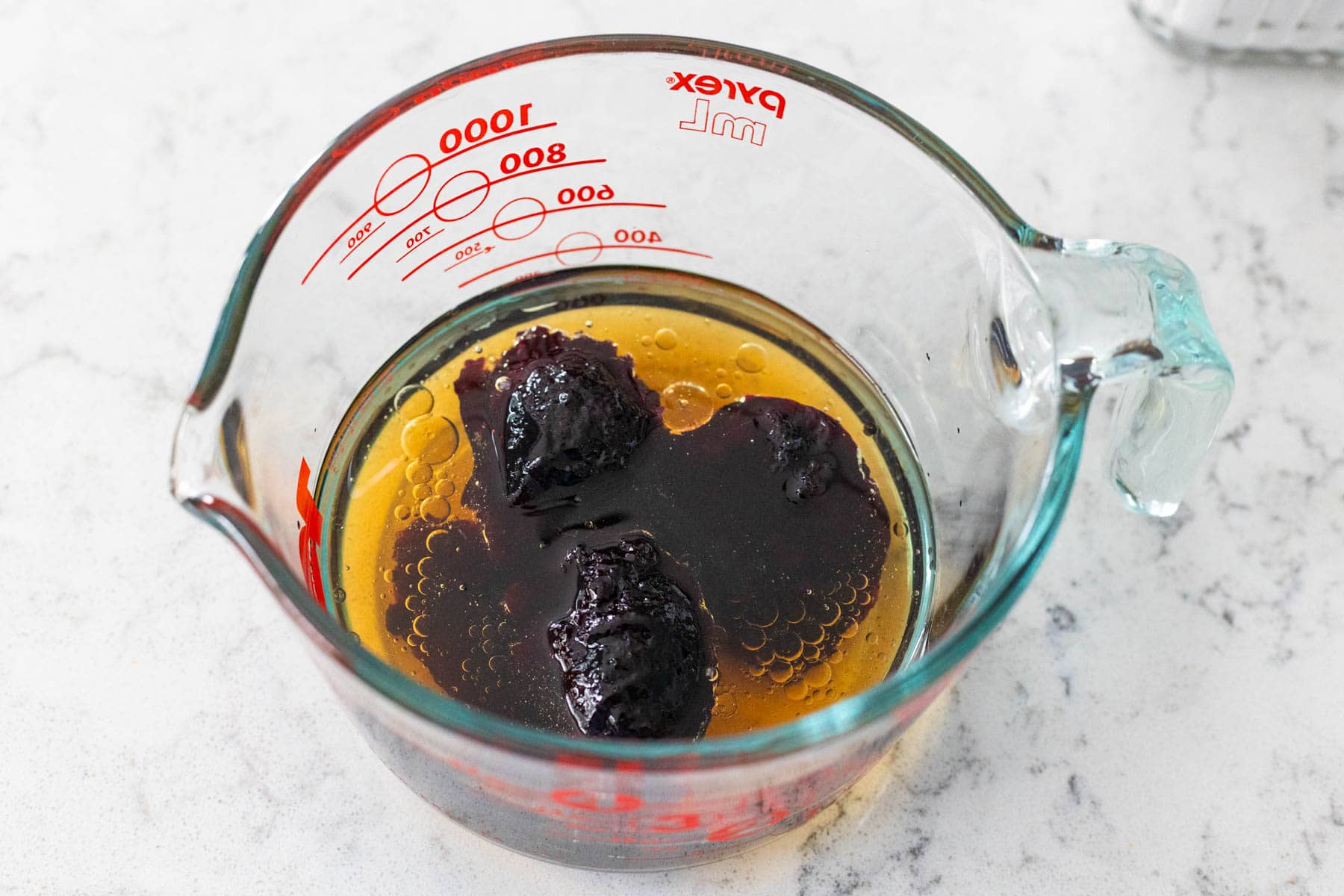 The vinegar and blueberry preserves are in a large mixing bowl.