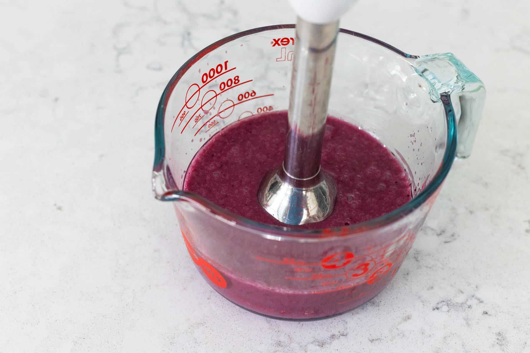 An immersion blender has blended the dressing together.