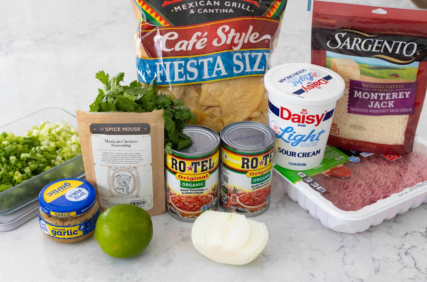 The ingredients to make Nacho Casserole are on the kitchen counter.