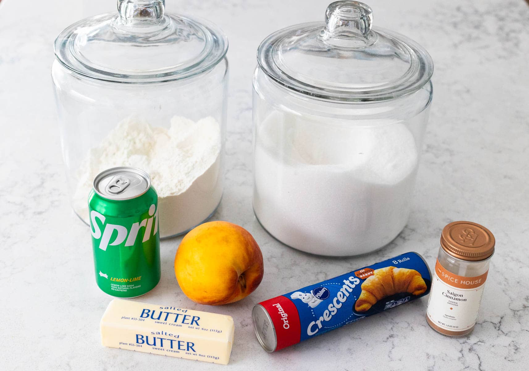 The ingredients to make homemade peach dumplings are on the kitchen counter.