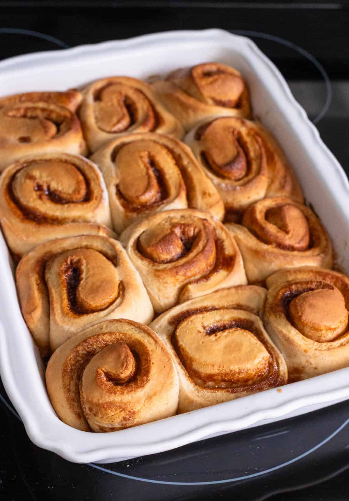 The baking pan is filled with golden brown baked rolls.