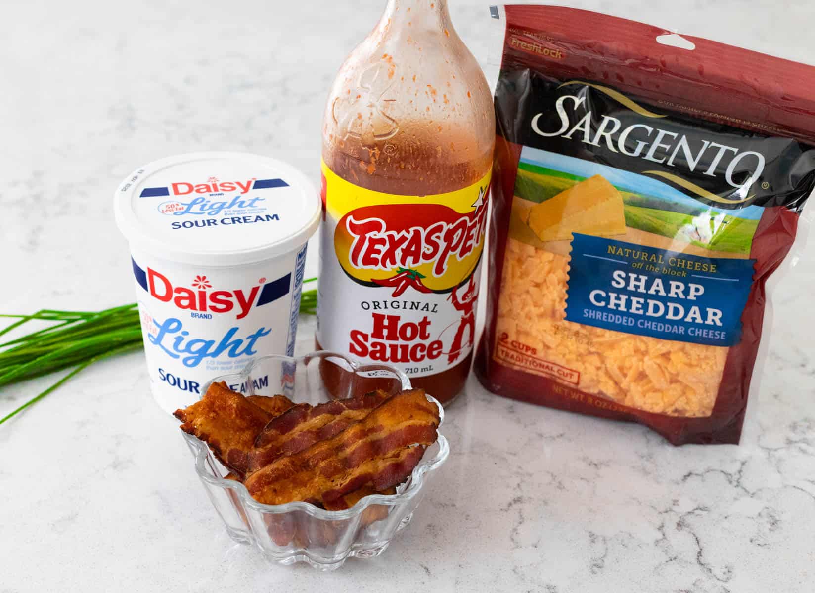 The ingredients to make Baked Potato Dip are on the kitchen counter.