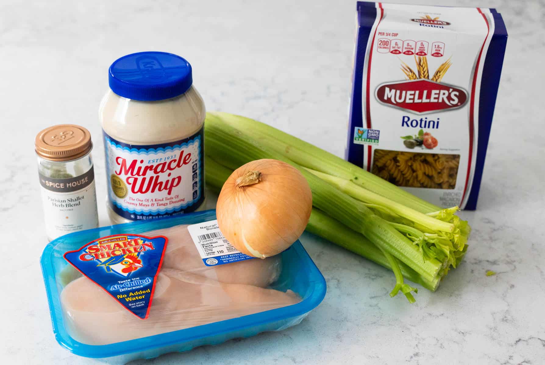 The ingredients to make Chicken Salad Pasta Salad are on the kitchen counter.