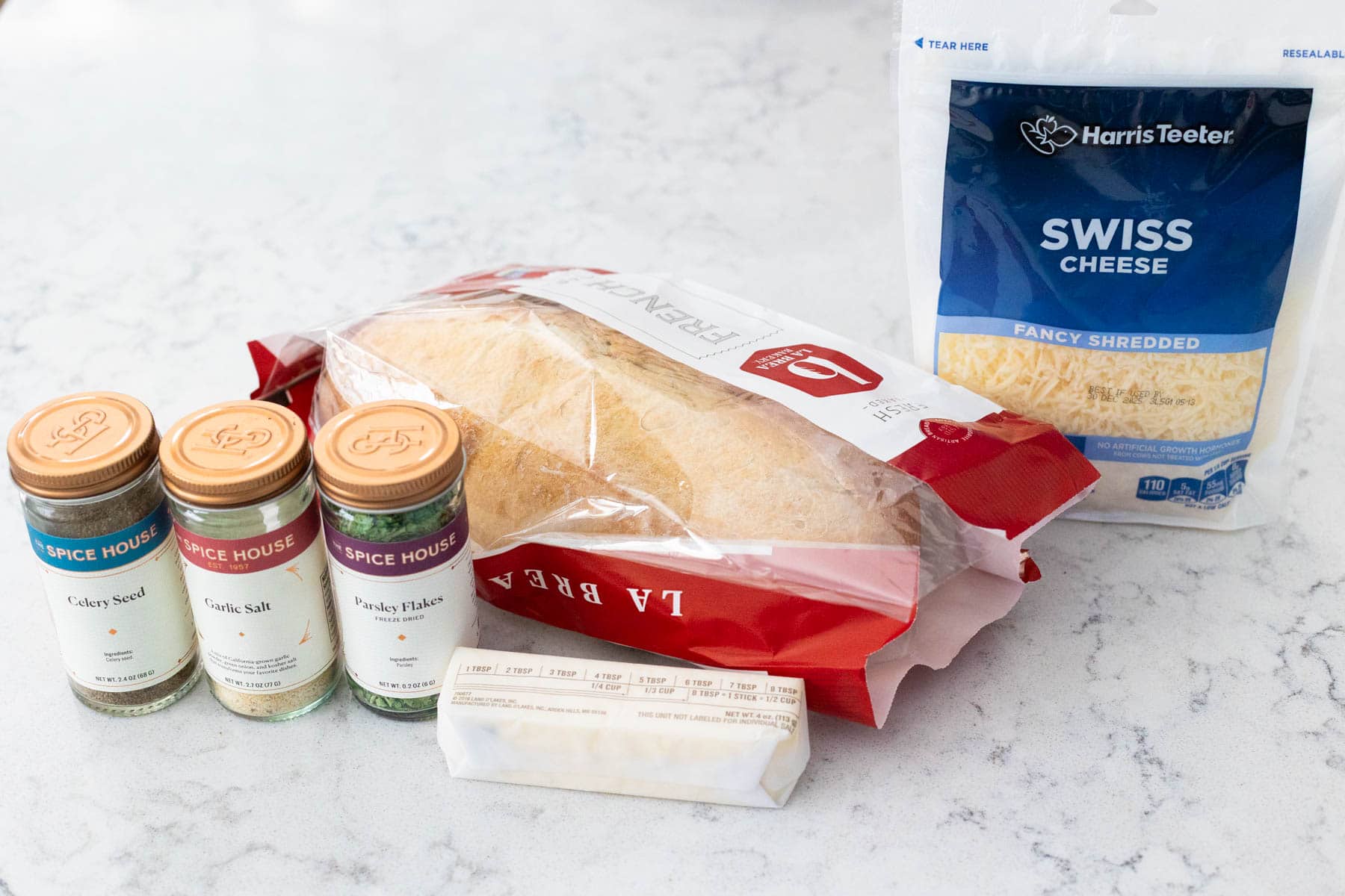 The ingredients to make Swiss Cheese Bread are on the kitchen counter.