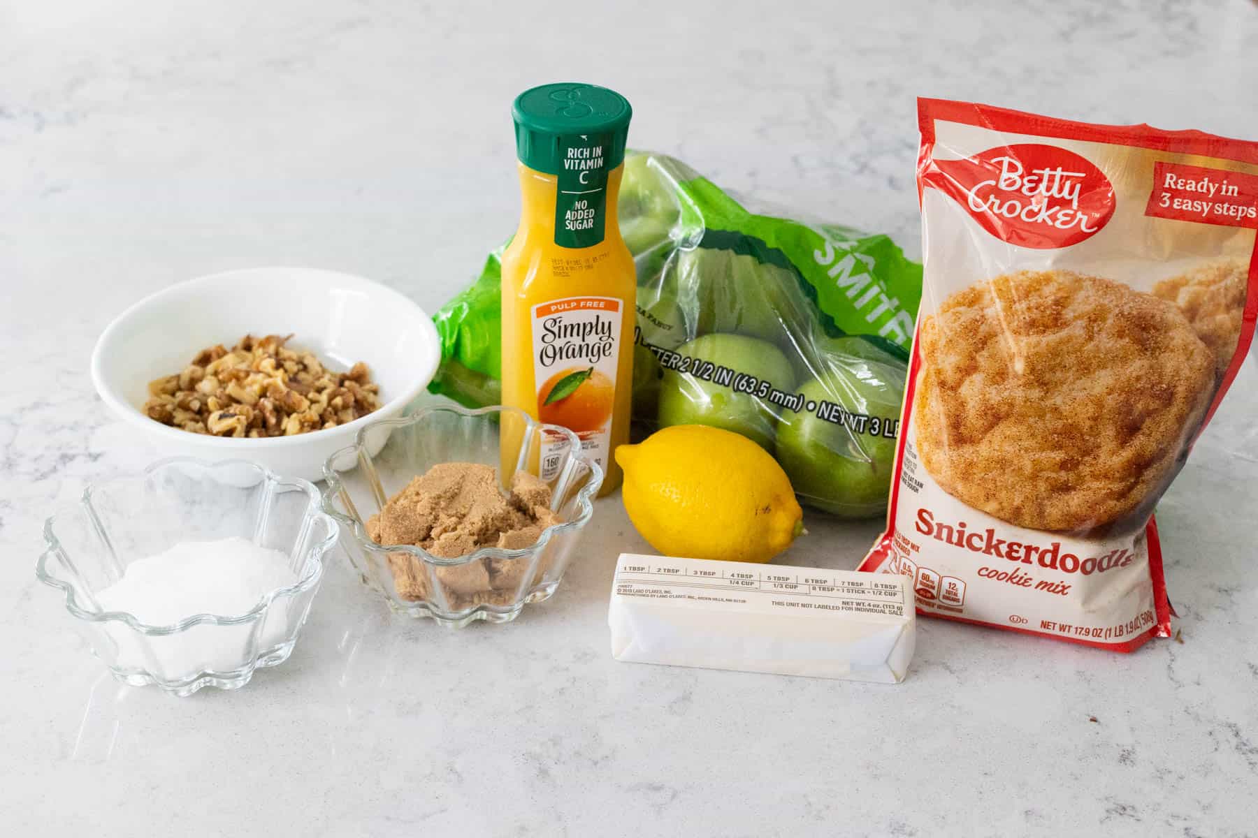 The ingredients to make Apple Snickerdoodle Dump Cake are on the kitchen counter.