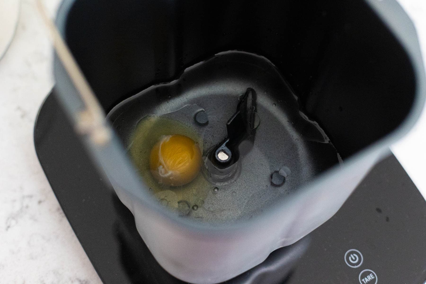 The egg, canola oil, and water are in the bread machine pan.