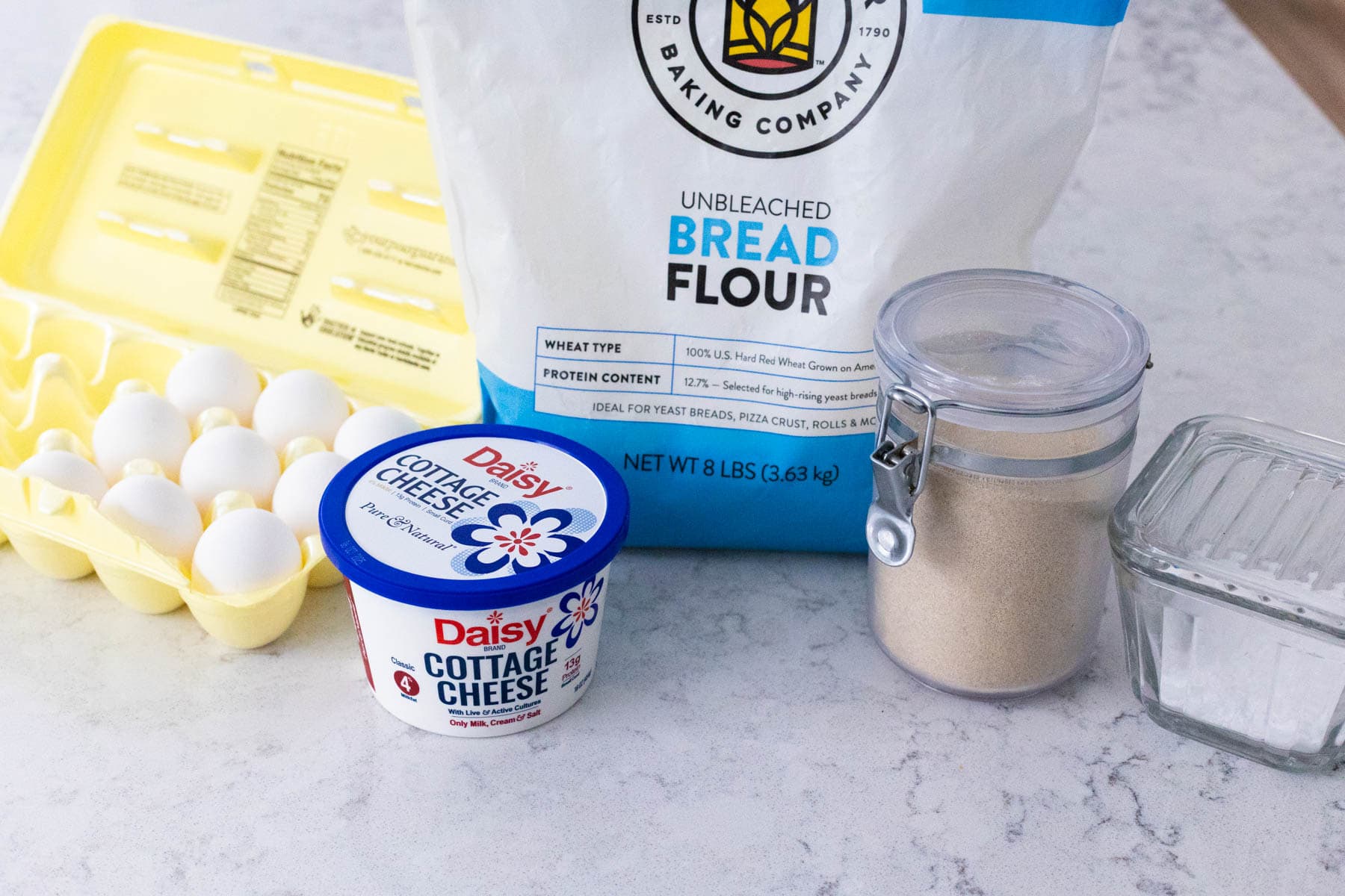 The ingredients to make Cottage Cheese Bread are on the kitchen counter.