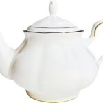 A white tea pot with metal trim.