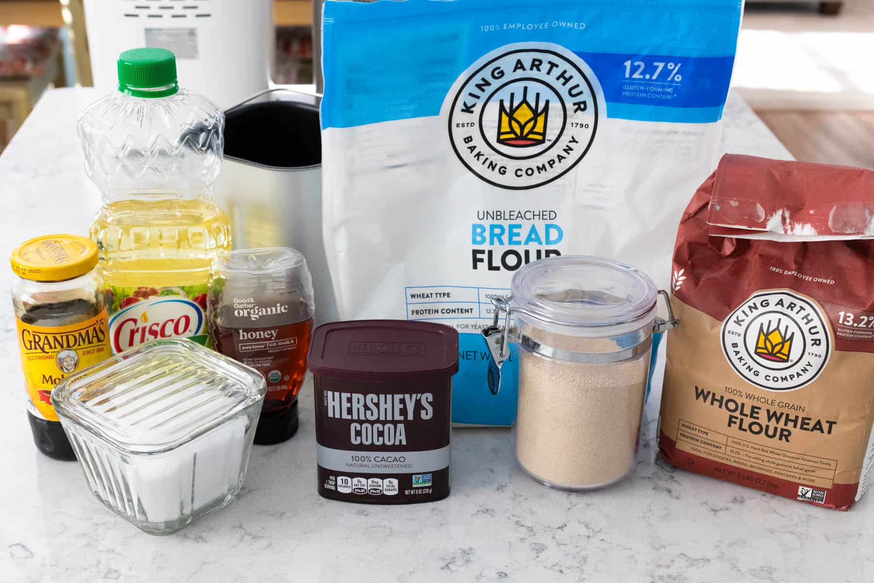 The ingredients to make Brown Bread Rolls are on the kitchen counter.