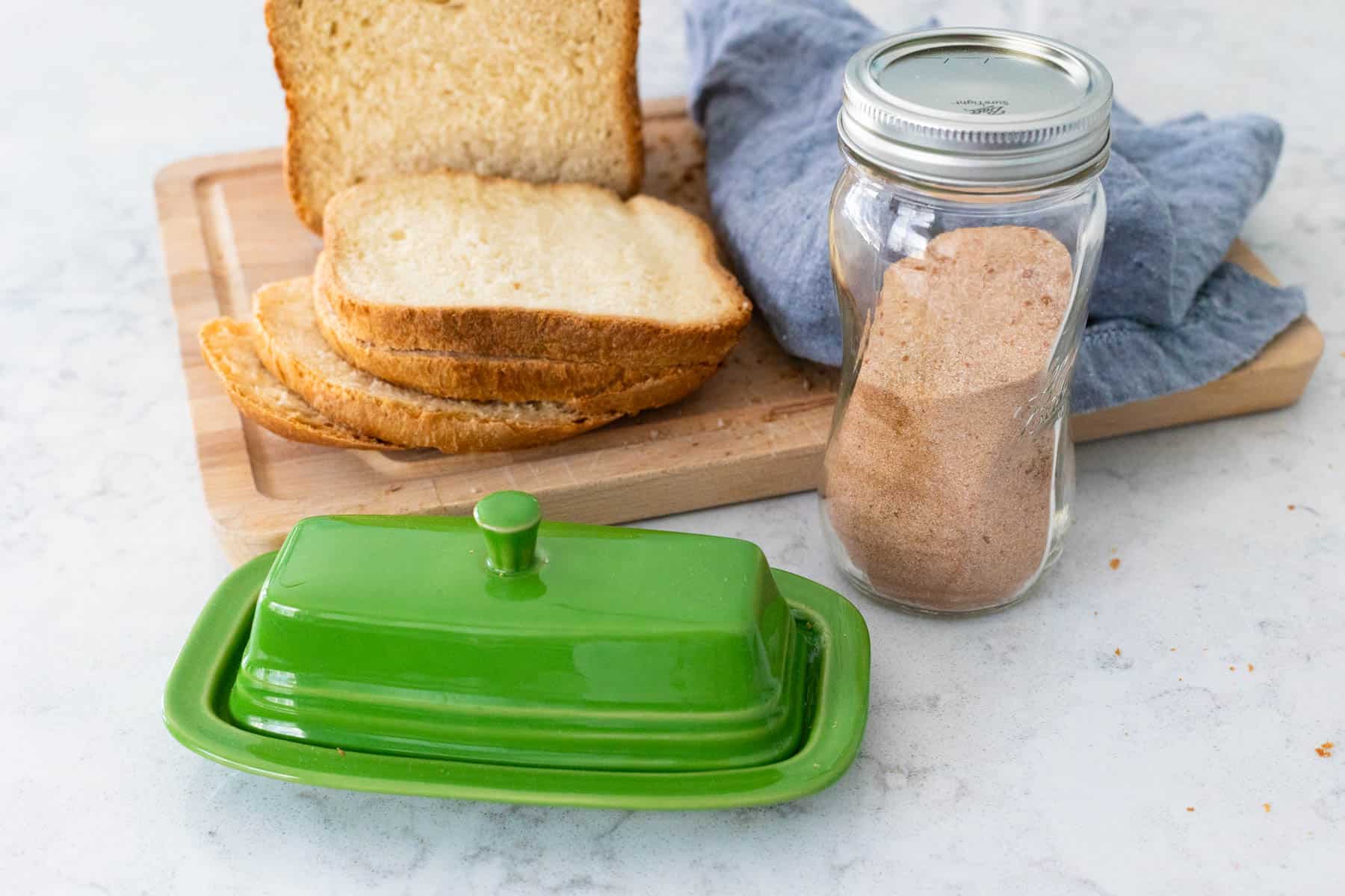 The ingredients to make cinnamon toast are on the counter.