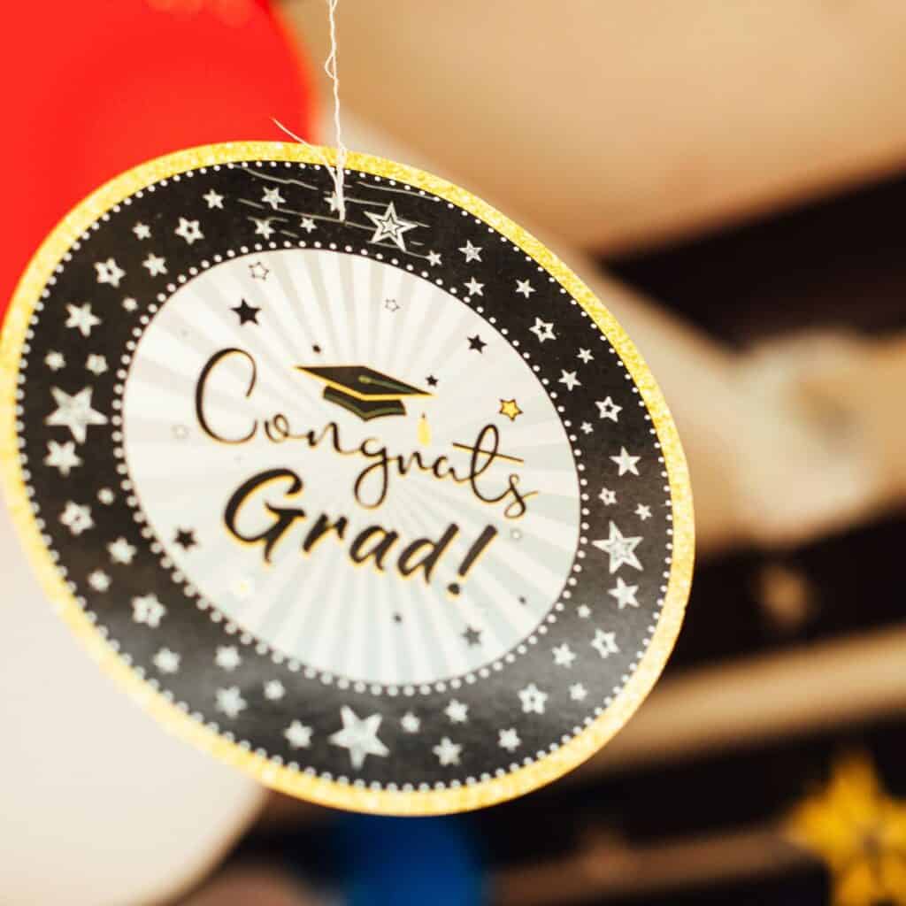 A "Congrats Grad!" Paper Decoration hangs from the ceiling.