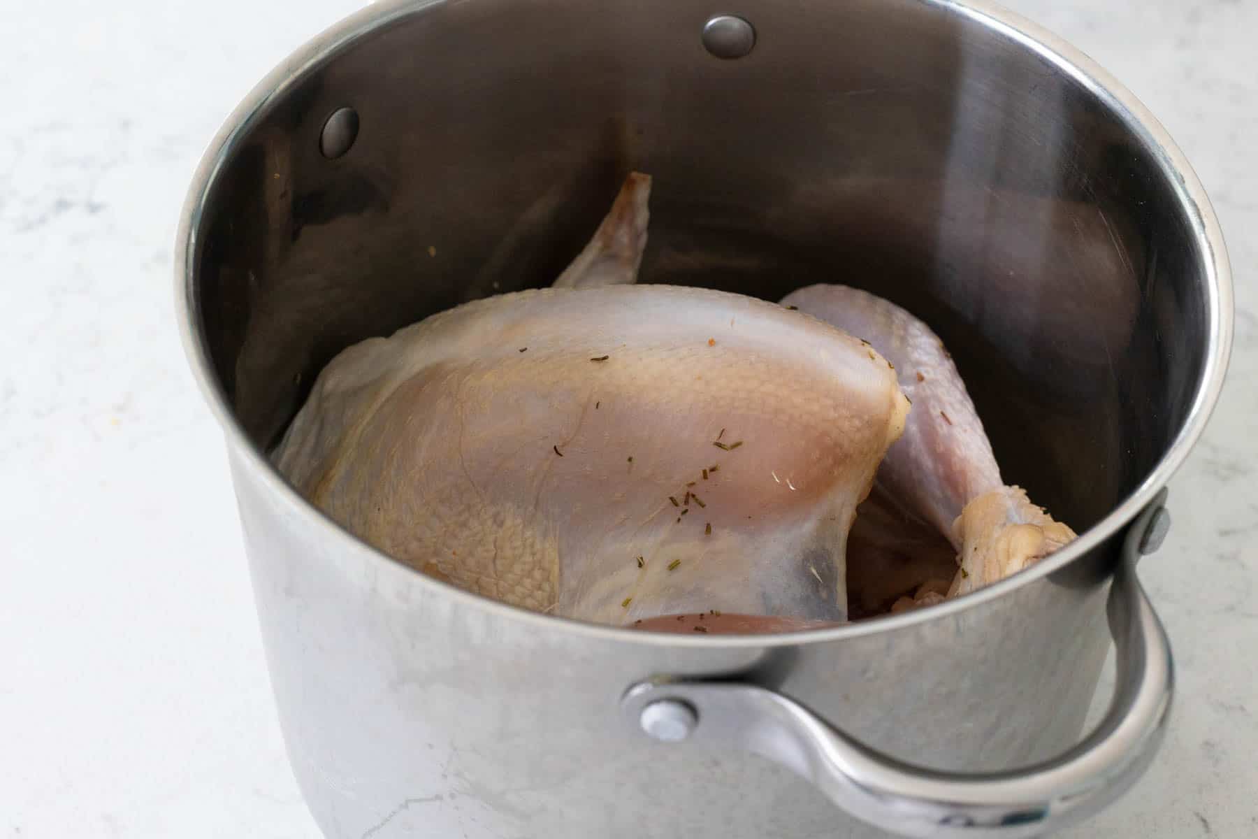The turkey has been dried and placed in a clean, dry pot to air out in the fridge.
