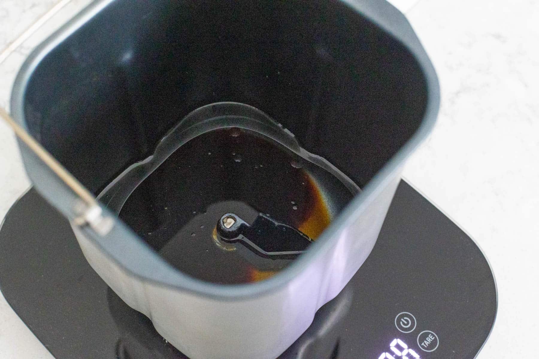 The water, molasses, and canola oil are in the bread maker pan.