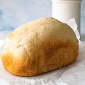 A loaf of sourdough bread that was baked in a bread machine.