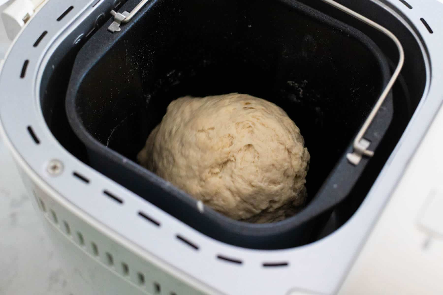 The sourdough dough ball has taken shape in the bread pan.