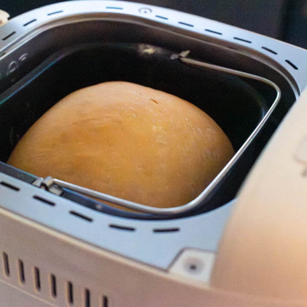 The baked loaf of sourdough bread is just finished baking in the bread machine.