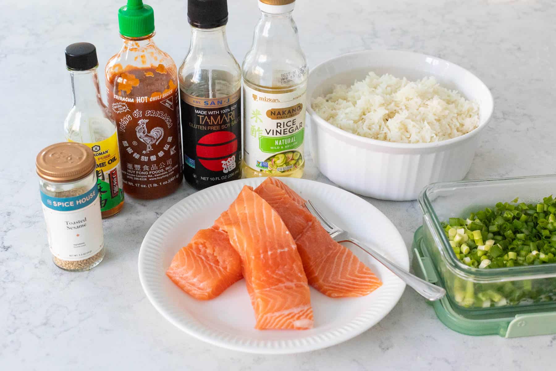 The ingredients to make Spicy Salmon Sushi are on the kitchen counter.