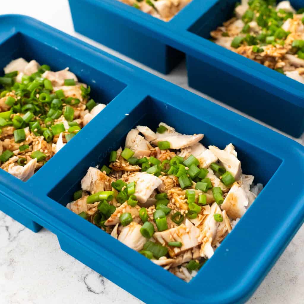The teriyaki chicken rice bowls have been portioned into freezer containers for meal prep.