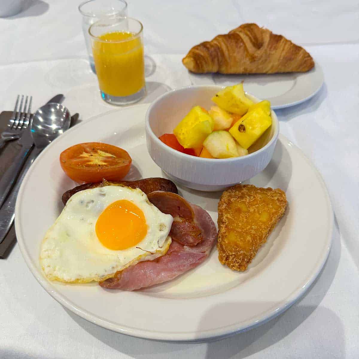 A plate filled with eggs, ham, potatoes, and a tomato as seen in a hotel in Dublin.