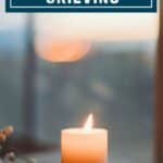 A single candle glows in the window.